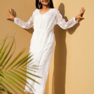 Stylish woman in a white chikankari kurti outdoors, showcasing ethnic elegance.